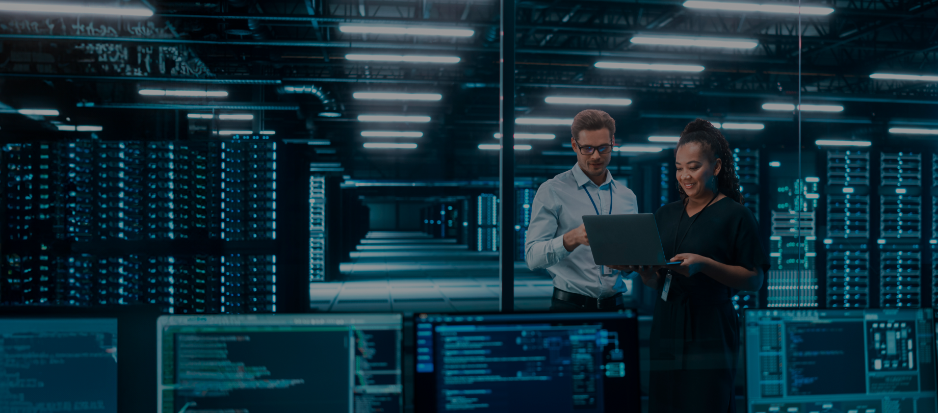 IT engineer conducting software tests in a high-tech data center as part of software quality assurance services.